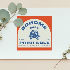 May include: A white card with a red and white logo that says "BOHOME 2020" in a blue arch with a blue rose in the centre. The text "CHI PRINTABLE LA" is below the arch and the text "DIGITAL AND PRINTABLE" is below that.
