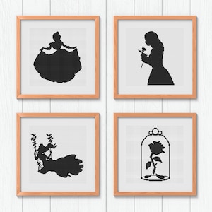 May include: Four framed cross-stitch artworks featuring black silhouettes of characters from a fairy tale. The images include a woman in a ball gown, a woman holding a rose, a woman on a swing, and a rose in a glass case.