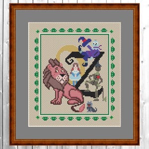 May include: Cross-stitch artwork featuring characters from The Wizard of Oz, including a lion, Dorothy, Scarecrow, Tin Man, and Toto, arranged around a stylized letter "Z". The artwork is framed in a brown wooden frame.