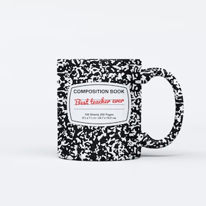 May include: A white ceramic mug with a black and white composition book design. The mug features the text "COMPOSITION BOOK" and "Best teacher ever" in red. The mug is 9&frac34; x 7&frac12; inches / 24.7 x 19.0 cm.