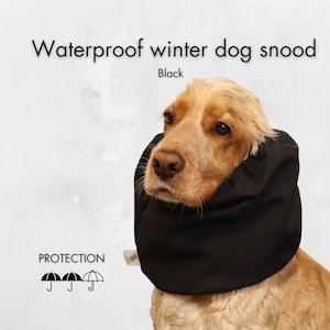 May include: A black waterproof dog snood, designed to protect a dog's neck and ears from the elements. The snood is made of a water-resistant material and features a comfortable fit. The image shows a dog wearing the snood, with the text "PROTECTION" and three umbrella icons below.