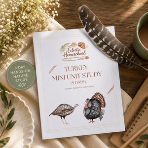 May include: A white booklet titled "Turkey Mini Unit Study" with illustrations of turkeys. The booklet is part of a 5-day hands-on nature study. A large feather and a cup of coffee are also visible.