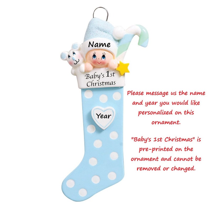 May include: Blue and white personalized Christmas stocking ornament with a baby boy wearing a Santa hat and holding a candy cane. The ornament has the text "Baby's 1st Christmas" and a space for a name and year.