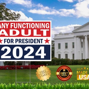 May include: A red, white, and blue political yard sign with the text "ANY FUNCTIONING ADULT FOR PRESIDENT 2024". The sign is in front of a white building with columns. The sign includes a gold star on each side of the text "FOR PRESIDENT".