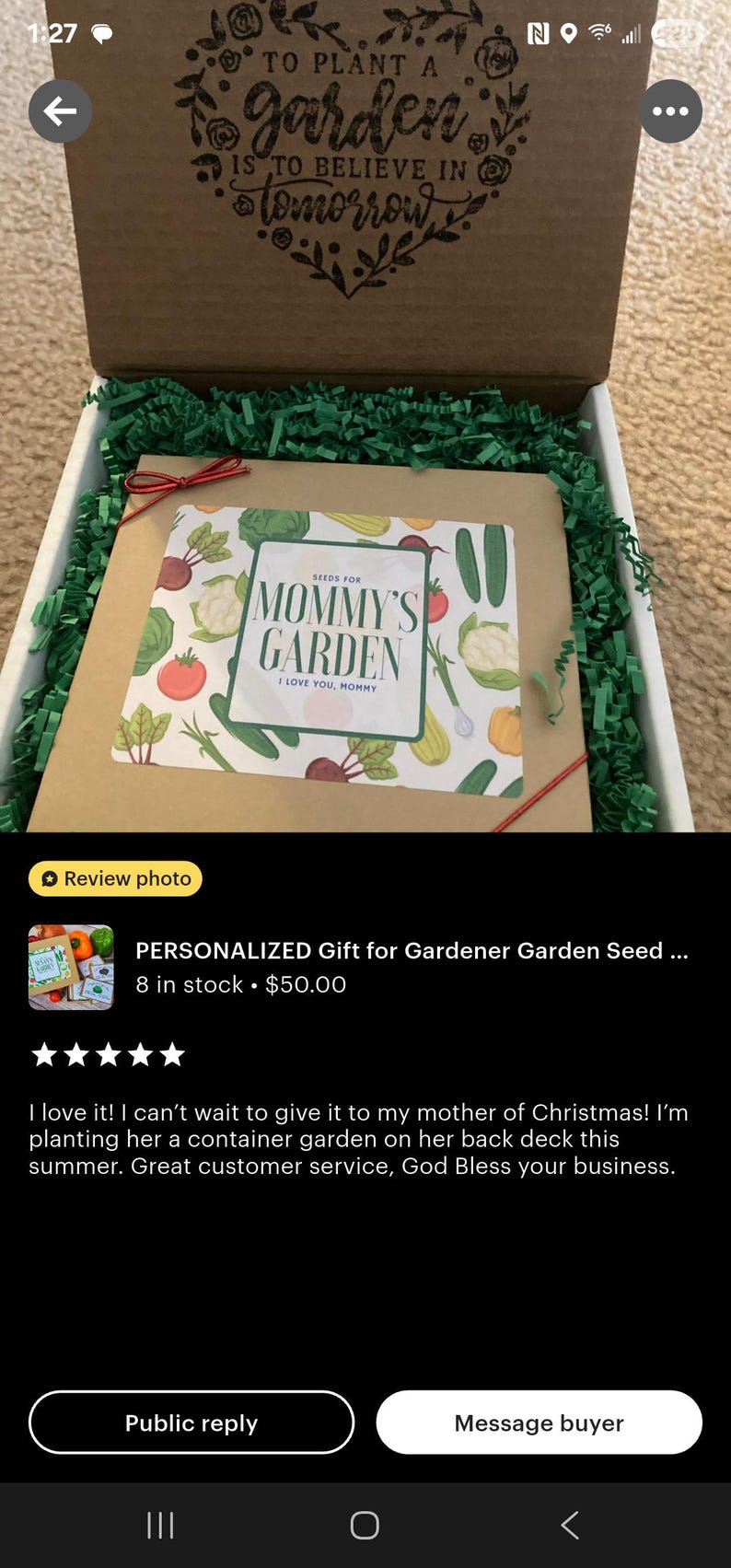May include: A gift box with a seed packet labeled "Mommy's Garden" featuring illustrations of vegetables. The box is filled with green paper shreds and has the text "To plant a garden is to believe in tomorrow" on the lid.