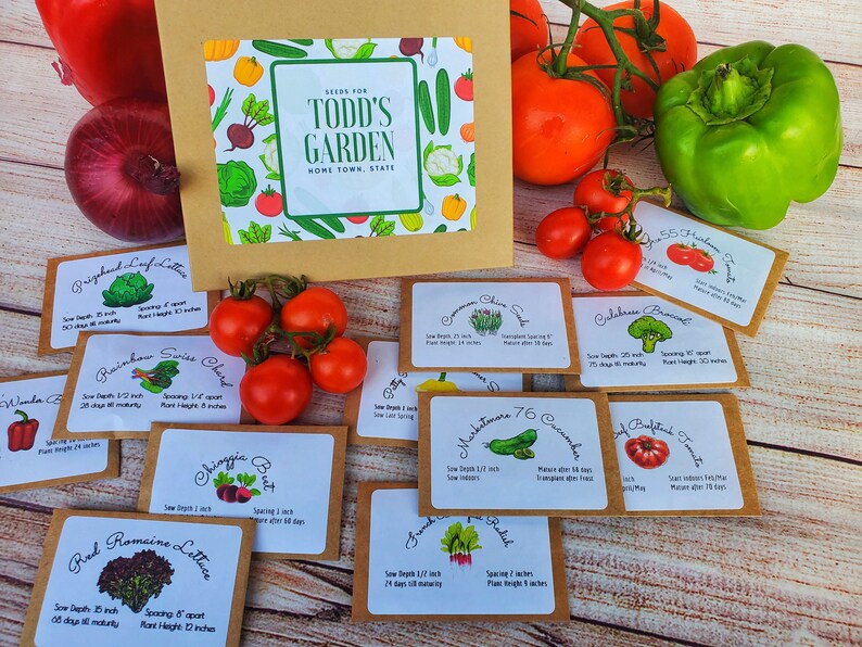 May include: A collection of seed packets for "Todd's Garden" with various vegetable illustrations. The packets are arranged with fresh produce like tomatoes, peppers, and onions. The packets include information on sowing depth, spacing, and plant height.