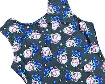 May include: A dark gray one-piece swimsuit featuring a repeating pattern of a superhero character in white, pink, and blue. The swimsuit has a scoop neckline and sleeveless design, with white stars scattered across the fabric.