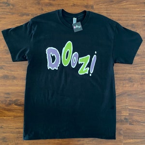 May include: Black t-shirt with a green and purple graphic that says "DOOZI!"