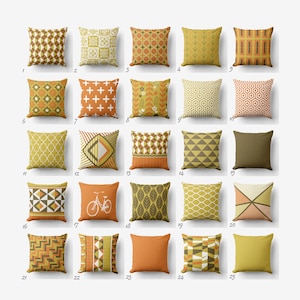 May include: A collection of 25 square throw pillows in various patterns and colors, including geometric designs, floral motifs, and solid colors. The pillows feature shades of orange, yellow, and brown, suitable for home decor.