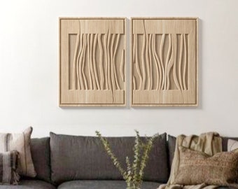 May include: A gray sectional sofa with a white throw blanket and pillows. A round wooden coffee table with a white top and a lower shelf. The coffee table has three rolled blankets on the lower shelf. A white rug with brown flecks is on the floor. Two wooden wall sculptures with a wavy pattern are on the wall.