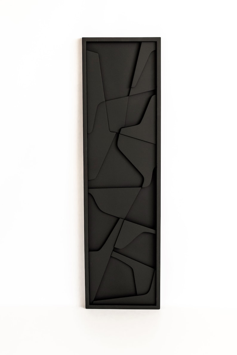 May include: Black framed wall art with a geometric design of overlapping shapes.