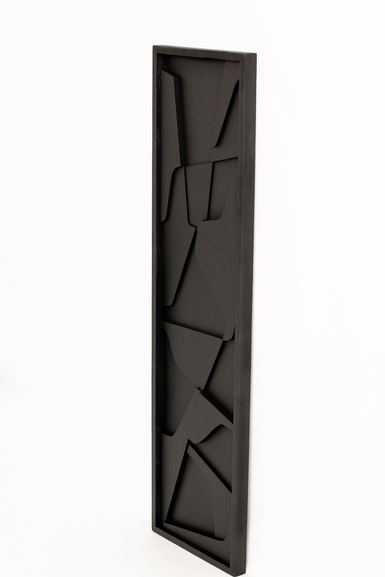 May include: Black framed wall art with a geometric design. The art is made of wood and has a 3D effect.