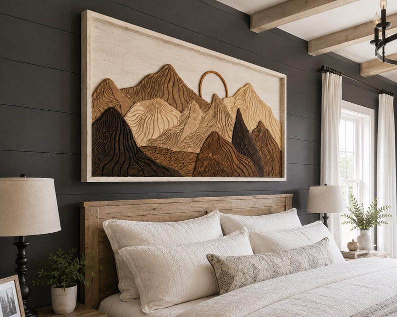 May include: A rectangular wall art piece featuring a layered wooden mountain landscape with a circular sun element. The artwork displays various shades of brown, tan, and cream wood tones with carved textures, all enclosed within a light-coloured frame.