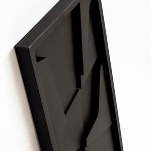 May include: Black framed wall art with a geometric design featuring multiple overlapping shapes.