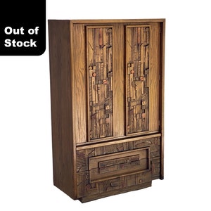 May include: A mid-century modern wooden armoire with a unique geometric pattern on the doors and a single drawer. The armoire is made of dark wood with a warm brown finish.