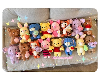 May include: A collection of 17 crocheted stuffed animals, including Winnie the Pooh, Tigger, Piglet, Eeyore, and Rabbit. The animals are all different colors and have different expressions on their faces. The stuffed animals are sitting on a white and gray couch.