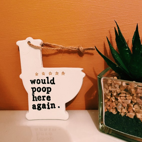 A handmade clay toilet bathroom ornament with 76 favorites — demand-validated, handcrafted, and perfectly dumb in the best white-elephant way.