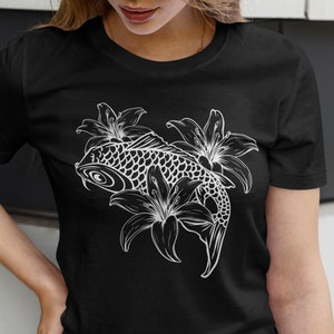 May include: A black t-shirt with a white graphic of a koi fish swimming through lilies.