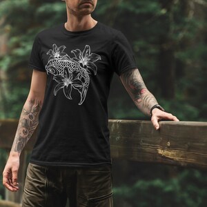 May include: Black t-shirt with a white graphic of a koi fish swimming through lilies.