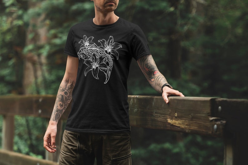 May include: Black t-shirt with a white graphic of a koi fish swimming through lilies.