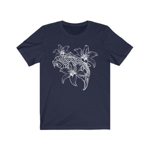 May include: A navy blue t-shirt with a white outline of a koi fish swimming through lilies.
