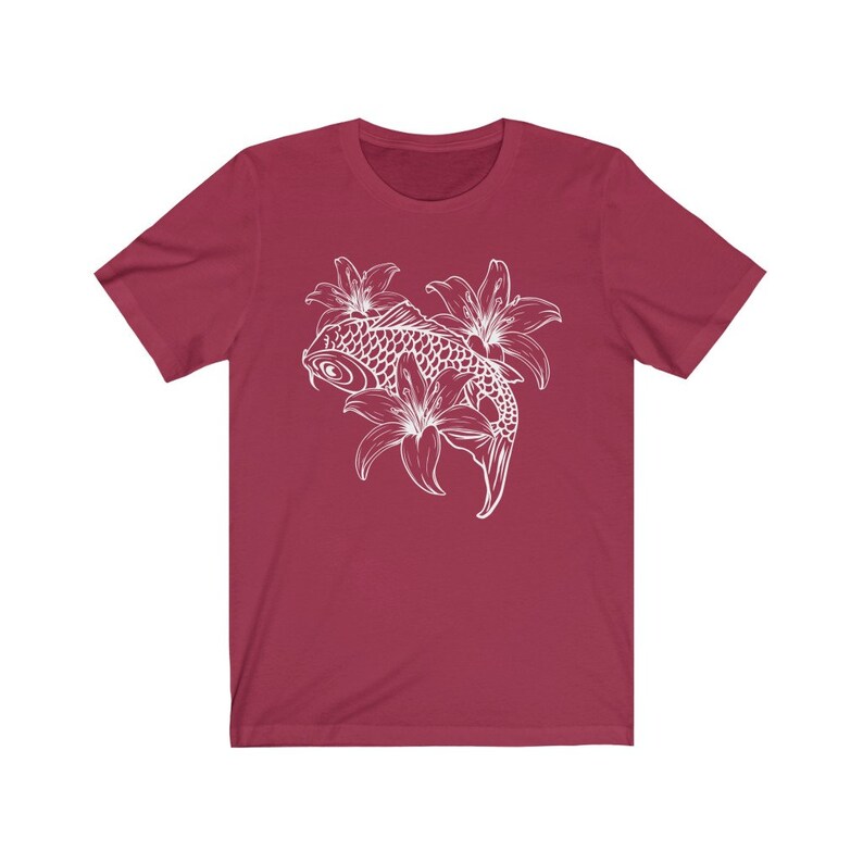 May include: A maroon t-shirt with a white outline of a koi fish swimming through lilies.