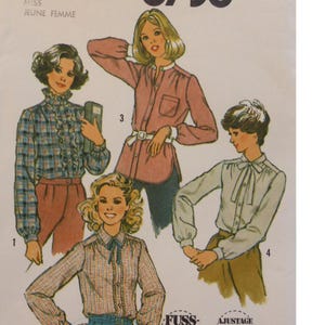 May include: Vintage sewing pattern featuring illustrations of four different blouses. The blouses include a plaid ruffle-front blouse, a pink button-down tunic with a belt, a plaid blouse with a bow, and a white blouse with a bow.