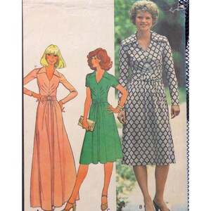 May include: Vintage sewing pattern featuring three dress designs. One dress is a long, light pink dress with long sleeves and a belt. Another is a green dress with short sleeves and a belt. The third dress is a black and white patterned dress.