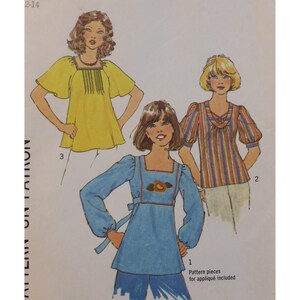May include: A vintage sewing pattern showing three blouse designs. The illustrations depict a yellow top with fringe, a striped top with puffed sleeves, and a blue top with an appliqué design. Pattern pieces for appliqué are included.