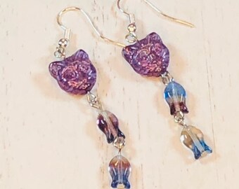 May include: Purple cat face dangle earrings with blue and purple glass beads.