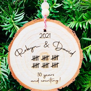 May include: A wooden ornament with the text "2021 Robyn & David" and "30 years and counting!" with tally marks representing 30 years.