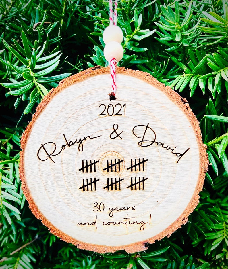 May include: A wooden ornament with the text "2021 Robyn & David" and "30 years and counting!" with tally marks representing 30 years.