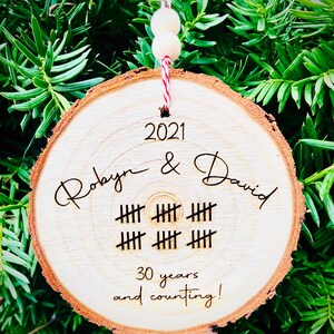 May include: A wooden ornament with the text "2021 Robyn & David" and "30 years and counting!" with tally marks representing 30 years.