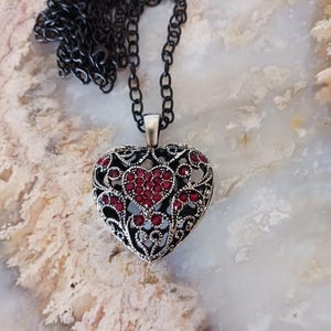 May include: A trio of cream-glazed ceramic mugs, each adorned with a hand-painted floral pattern in pinks, blues, and greens. The mugs have a speckled finish and a classic, rounded design with a handle. Ideal for tea or coffee.