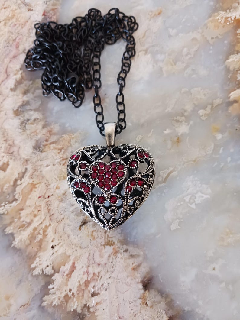 May include: A trio of cream-glazed ceramic mugs, each adorned with a hand-painted floral pattern in pinks, blues, and greens. The mugs have a speckled finish and a classic, rounded design with a handle. Ideal for tea or coffee.