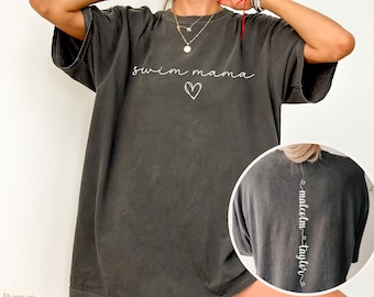 May include: A dark gray oversized t-shirt with the text "swim mama" and a heart on the front. The back of the shirt has the text "malcolm - taylor" vertically down the back.