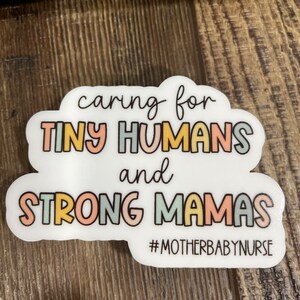 May include: A white sticker with the text "caring for tiny humans and strong mamas #motherbabynurse" in rainbow colours.