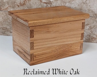 May include: A wooden box made from reclaimed white oak. The box has a hinged lid and is made with a dovetail joint.