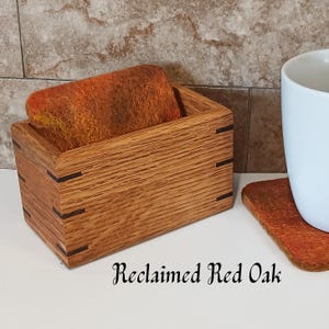 May include: A set of three ceramic mugs with a speckled, matte finish. The mugs are in shades of cream, light gray, and dark gray. Each mug has a simple, minimalist design and a rounded handle. The mugs are stacked on top of each other.