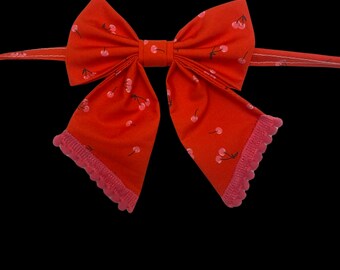 Cherry Cherry, pet sailors bow tie, red with pink cherries and hot pink pompom trim.