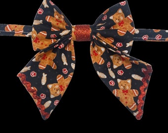 Gingerbread kitties, pet sailors bow tie, black with gingerbread cats, little fish & paws. With a sparkly red center and metallic trim