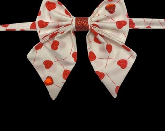 Lovely Lollipops, pet sailors bow tie, white with red heart shaped lollipops. With red heart gem details and red sparkly center.