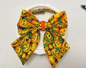 Jack O Lantern sailors bow tie with orange velvet center. For cats and dogs Available with attached collar or over the collar style
