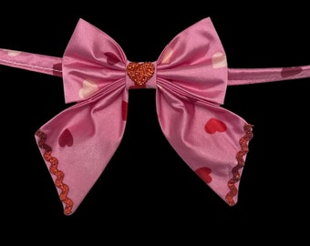 The Romantic, pet sailors bow tie, pink satin with red and pink hearts. With metallic red ricrac trim and sparkly red heart decal center.