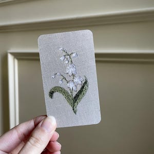 May include: A white ceramic mug with a black handle and the text "But First, Coffee" in a handwritten style. The mug is likely 12-16 ounces, perfect for a morning beverage.