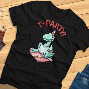 May include: Black t-shirt with a green dinosaur wearing a party hat and holding a teacup. The text "T-PARTY!" is printed above the dinosaur.