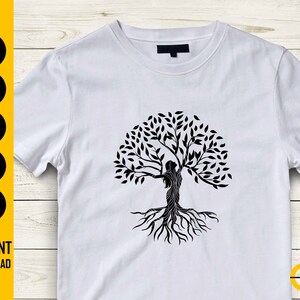 May include: White t-shirt featuring a black graphic of a tree with a woman's silhouette incorporated into the design. The shirt has a crew neck and short sleeves. The words "SVG, DXF, PNG, EPS, AI" are printed on the left side, with "INSTANT DOWNLOAD" below.