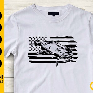 May include: White t-shirt featuring a black and white graphic of a catfish superimposed over a stylized American flag. The shirt also includes the text "INSTANT DOWNLOAD" and various file type icons on the left side.
