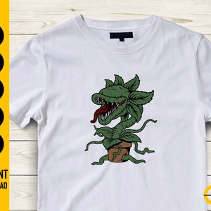 May include: White t-shirt featuring a green plant monster with a red tongue, in a brown pot. The design is a cartoon illustration. The left side of the shirt has the text "SVG, DXF, PNG, EPS, AI" and "INSTANT DOWNLOAD".