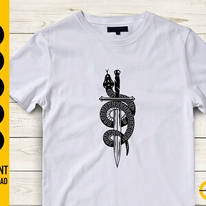 May include: White t-shirt featuring a black graphic of a snake coiled around a sword. The design includes the text "SVG, DXF, PNG, EPS, AI" and "INSTANT DOWNLOAD". The ButterStar Digital logo is visible.